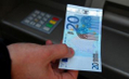 Une personne retire de l'argent à un guichet automatique à Dublin, en Irlande, le 22 Novembre 2010. (Peter Muhly/Getty Images)（攝影:  / 大紀元）  