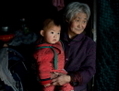 Photo prise le 21 mars 2013 montrant une femme avec l’un de ses petits-enfants dans leur maison à Chengde, province du Hebei. Chengde est une ville où les habitants ne sont pas soumis à la politique de contrôle de l’enfant unique comme dans les autres parties de la Chine. La politique coercitive de l’enfant unique était à l’ordre du jour lors de la rencontre du 18e Comité central du Parti qui s’est déroulée du 9 au 12 novembre. (Ed Jones/AFP/Getty Images)