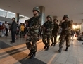 3 mars 2014: Des paramilitaires chinois patrouillent aux alentours du lieu de l’attaque qui a eu lieu dans la gare principale de Kunming, province du Yunnan. Suite à cet acte de violence, les signes de discrimination enevrs les Ouïghours ont fait réagir certains membres du public chinois (Mark Ralston/AFP/Getty Images)