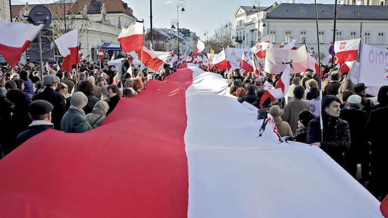 Des manifestants portent le drapeau polonais. (Marcin Lobaczewski/AFP/Getty Images)