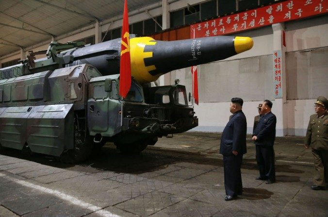 Cette photo publiée le 15 mai 2017 par l’agence de presse officielle nord-coréenne montre le dictateur nord-coréen Kim Jong-Un (g) inspectant un missile balistique stratégique Hwasong-12 dans un endroit tenu secret. (STR/AFP/Getty Images)