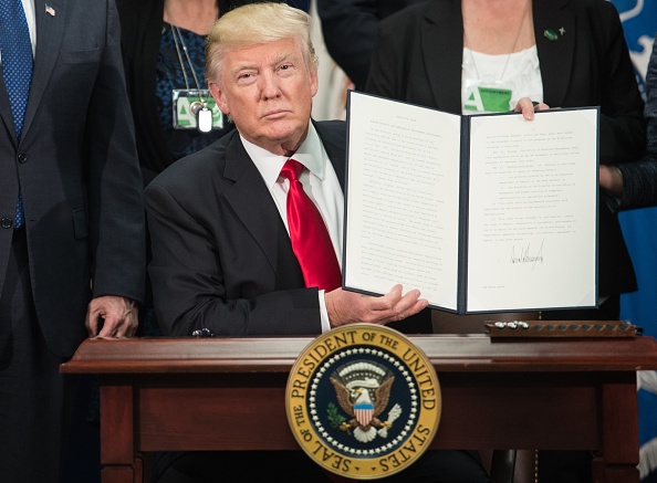 Le président américain Donald Trump signant un décret concernant le projet du mur à la frontière de Mexico àWashington, DC, le 25 janvier 2017.
(NICHOLAS KAMM/AFP/Getty Images)