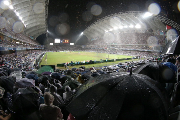 Les fans s'abritent sous les parapluies lors d'une pluie battante lors de la finale du Barclays Asia Trophy entre Manchester City et Sunderland au Hong Kong Stadium le 27 juillet 2013 à So Kon Po, Hong Kong. 
(Chris McGrath / Getty Images pour FA Premier League)