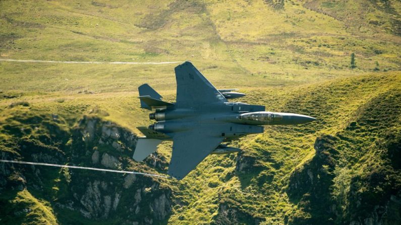 Un avion de chasse F-15 des Forces aériennes des États-Unis (USAF) circule à basse altitude dans la série de vallées de Mach Loop, près de Dolgellau, au nord du Pays de Galles, le 26 juin 2018. Photo OLI SCARFF / AFP / Getty Images.