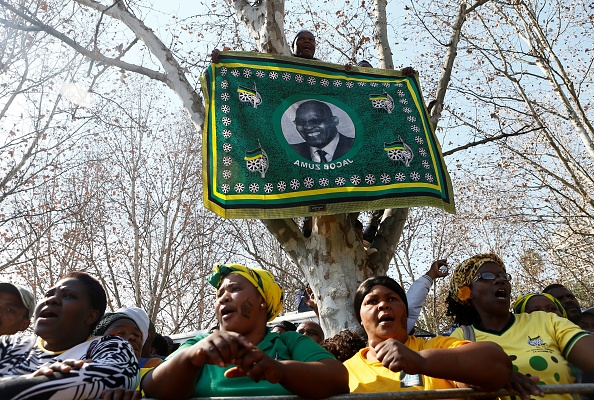 -Des opposants de l'ancien président sud-africain Jacob Zuma applaudissent devant la Haute Cour du KwaZulu-Natal de Pietermaritzburg le 27 juillet 2018 à la suite de l'audience sur 16 chefs d'accusation de corruption. Photo PHILL MAGAKOE / AFP / Getty Images.