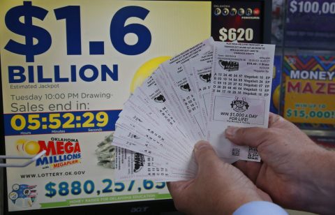 A customer, who did not want to be identified, displays the $200.00 worth of Mega Millions tickets he bought at Downtown Plaza convenience store in Oklahoma City, Tuesday, Oct. 23, 2018. (AP Photo/Sue Ogrocki)