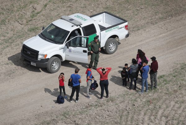 Des étrangers en situation irrégulière se rendent à un agent de la police des frontières après avoir quitté le Mexique pour les États-Unis à Mission, au Texas, le 7 novembre 2018. (John Moore/Getty Images) 