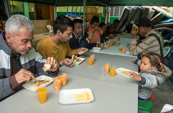 -Des migrants vénézuéliens déjeunent au refuge 'Sans frontières', dans le nord de Lima, le 31 août 2018. Il y a un an, l'entrepreneur péruvien du textile Rene Cobena a commencé à aider huit migrants vénézuéliens en leur offrant un repas par jour et une couchette. Maintenant, la maison qu'il a louée a été transformée en un refuge pouvant accueillir 200 personnes, dont 30 enfants, qui, grâce aux dons et à la bonne volonté de Cobena, bénéficieront d'un soutien leur permettant de repartir à zéro. Photo de CRIS BOURONCLE / AFP / Getty Images.