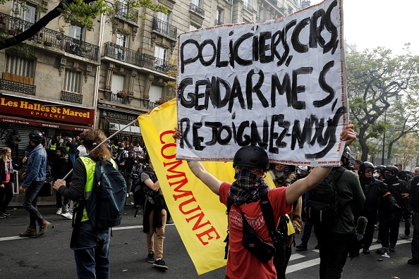 Un manifestant tient une pancarte "Police, CRS, gendarmes, rejoignez-nous" lors du rassemblement annuel du 1er mai 2019 à Paris.     (Photo : GEOFFROY VAN DER HASSELT/AFP/Getty Images)