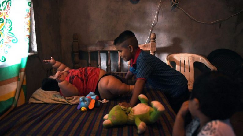 Luis Gonzales (G), 10 mois, est photographié avec son cousin Michel (C) et son frère Mario (D) chez lui à Tecoman, dans l'état de Colima, Mexique. Luis ne peut pas marcher ou même ramper. (Pedro Pardo/AFP/Getty Images)