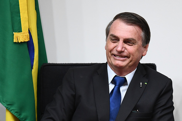 "Les incendies de forêt existent dans le monde entier et cela ne peut pas servir de prétexte à d'éventuelles sanctions internationales", a répliqué vendredi soir le chef de l'Etat brésilien, Jair Bolsonaro. (Photo : EVARISTO SA/AFP/Getty Images)