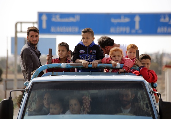 Les Syriens rentrent chez eux dans la ville d'Ayn al-Arus, au sud de la ville frontalière de Tal Abyad, le 14 octobre 2019, après que celle-ci ait été reprise par des combattants syriens soutenus par la Turquie alors qu'ils attaquaient des villes frontalières sous contrôle kurde en nord-est de la Syrie.(Photo : BAKR ALKASEM/AFP via Getty Images)