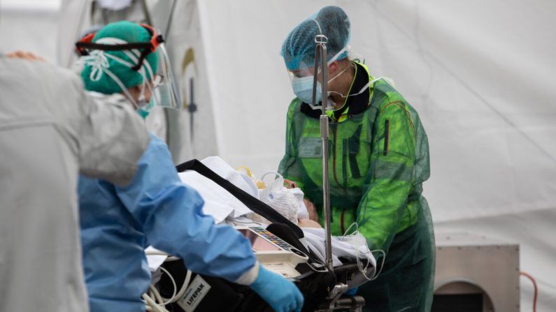 Un patient est traité par un médecin dans un hôpital de campagne d'urgence au Samaritan's Purse à Crémone, près de Milan, en Italie, le 20 mars 2020. Samaritan" (Emanuele Cremaschi/Getty Images)
