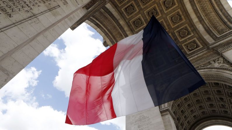 Un drapeau français est accroché sous le monument de l'Arc de Triomphe à Paris, pour la cérémonie marquant l'anniversaire de la Victoire en Europe le 8 mai 1945 (Photo by THOMAS SAMSON/AFP via Getty Images)