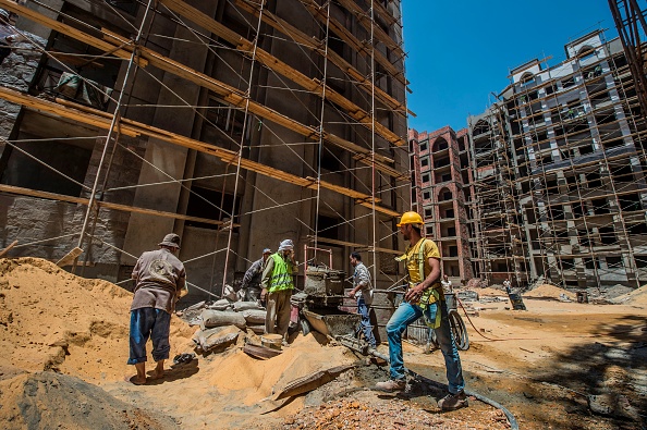 Des ouvriers travaillent sur le chantier de construction de la nouvelle capitale administrative égyptienne, à quelque 40 km à l'est du Caire. Photo Khaled DESOUKI/AFP via Getty Images.