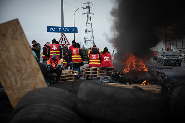 Des syndicalistes bloquent les accès au port du Havre, en Normandie, le 8 mars 2023, lors d'une journée d'action contre la réforme des retraites. (LOU BENOIST/AFP via Getty Images)