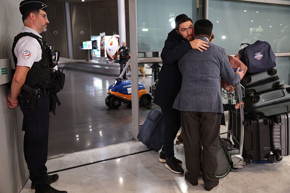Un passager est accueilli à son arrivée de Tel Aviv sur un vol pour ressortissants français, à l'aéroport Roissy-Charles-de-Gaulle, le 12 octobre 2023. (Photo MEHDI FEDOUACH/AFP via Getty Images)
