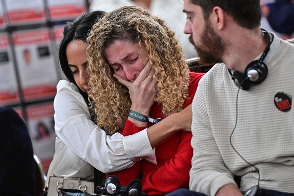 Adva Gutman, sœur d'un otage de la rave party (au c.) réagit lors d'un évènement appelant à la libération des otages détenus par le Hamas à la Grande Synagogue de Paris, le 31 octobre 2023. (Photo MIGUEL MEDINA/AFP via Getty Images)