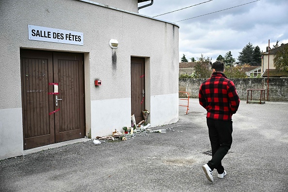 Un homme passe devant la salle de réception de Crepol où Thomas, un adolescent, est décédé le 19 novembre 2023 après avoir été blessé à l'arme blanche lors d'un bal dans ce petit village de la Drôme. (Photo OLIVIER CHASSIGNOLE/AFP via Getty Images)