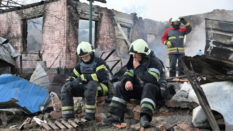 Des pompiers se reposent après avoir éteint un incendie dans une maison privée détruite par une attaque de drone russe dans la banlieue de Kharkiv, le 21 mai 2024, en Ukraine. (Photo SERGEY BOBOK/AFP via Getty Images)