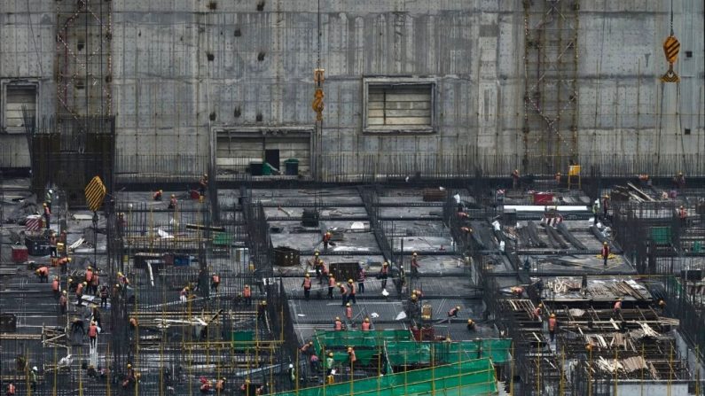 Des ouvriers du bâtiment travaillent sur un grand chantier dans le quartier central des affaires de Pékin, le 13 avril 2023. (Kevin Frayer/Getty Images)