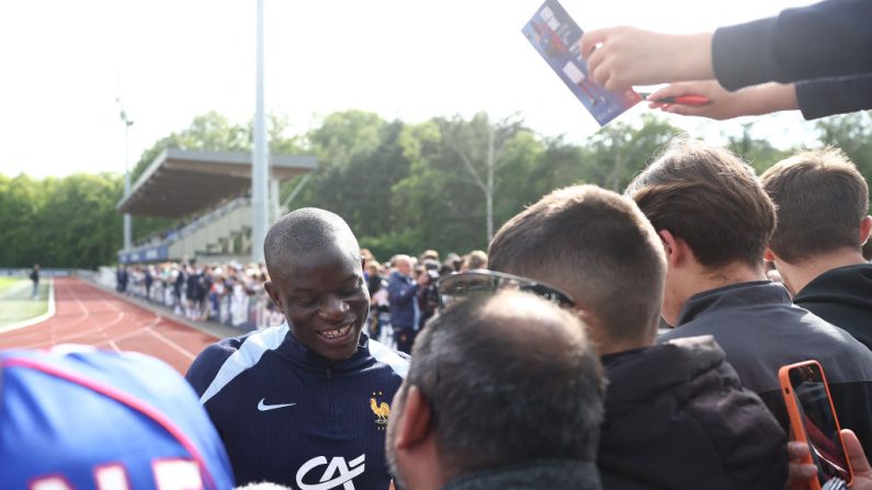 France's midfielder N'Golo Kante (C) signs autographs before a training session as part of the team's preparation for the UEFA Euro 2024 European football championships in Clairefontaine-en-Yvelines on June 2, 2024. (Photo by FRANCK FIFE / AFP) (Photo by FRANCK FIFE/AFP via Getty Images)