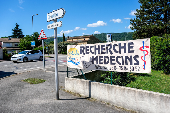 Une banderole indique que la municipalité recherche des médecins à l'entrée de la Roche de Glun. (NICOLAS GUYONNET/Hans Lucas/AFP via Getty Images)