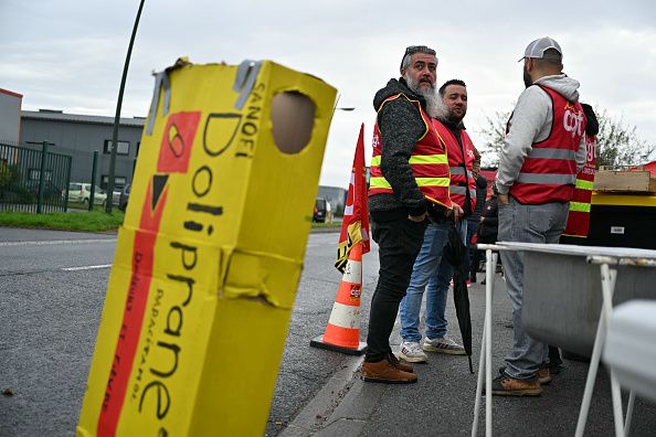 Des salariés et des syndicalistes devant l'usine de Sanofi à Lisieux, le 17 octobre 2024. (LOU BENOIST/AFP via Getty Images)