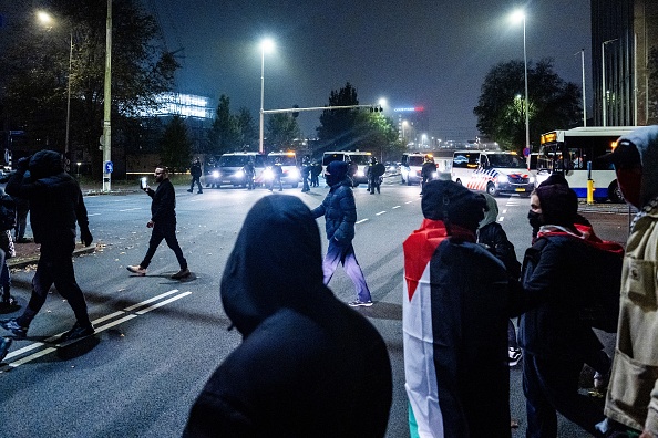 Des supporters avec des drapeaux palestiniens participent à une manifestation pro-palestinienne en marge du match de football de l'UEFA Europa League entre l'Ajax Amsterdam et le Maccabi Tel Aviv, à Amsterdam, le 7 novembre 2024. (JEROEN JUMELET/ANP/AFP via Getty Images)